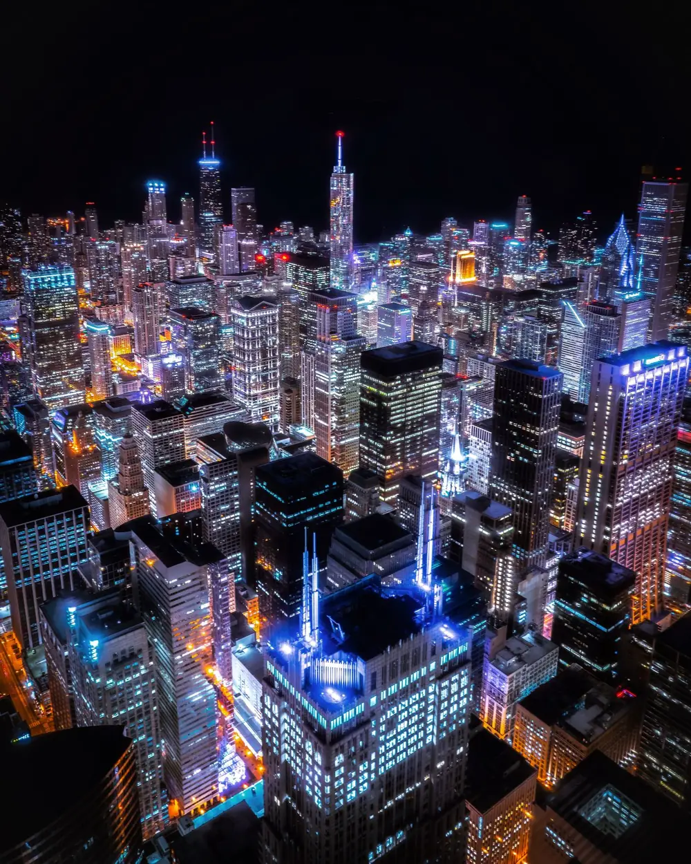 Aerial night view of a city skyline lit up