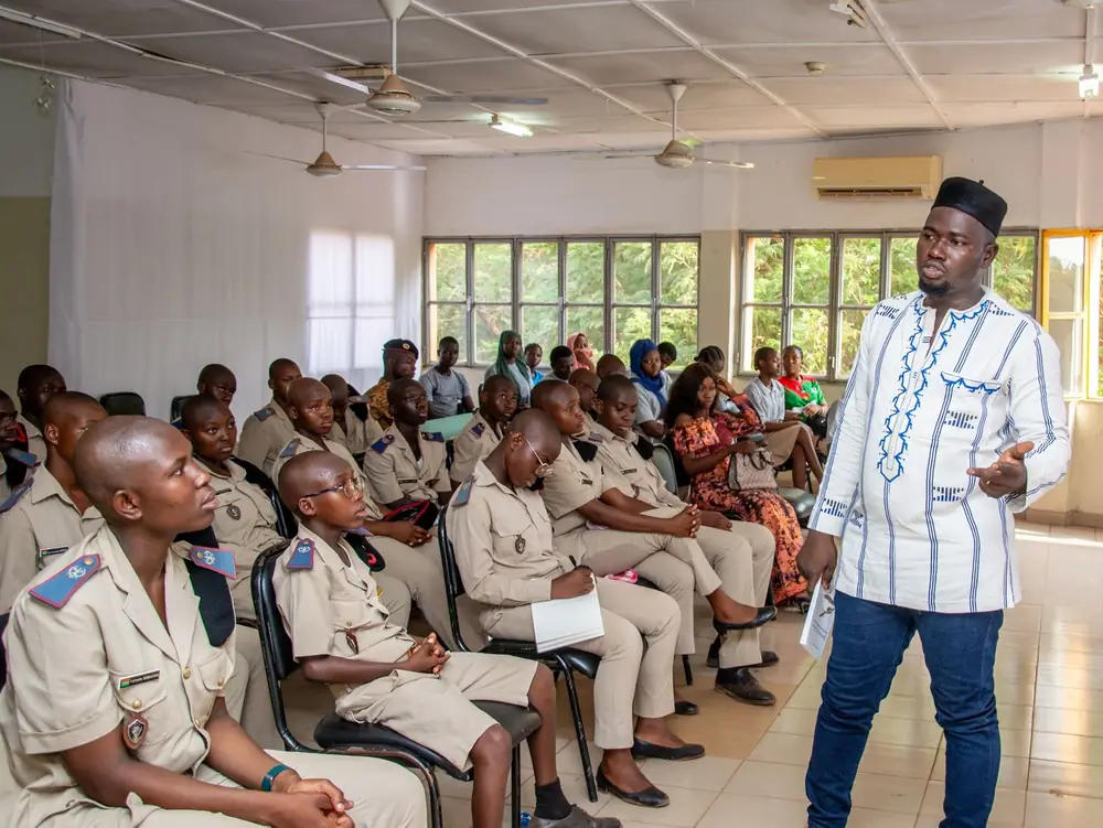 An instructor leading a training session in a full classroom