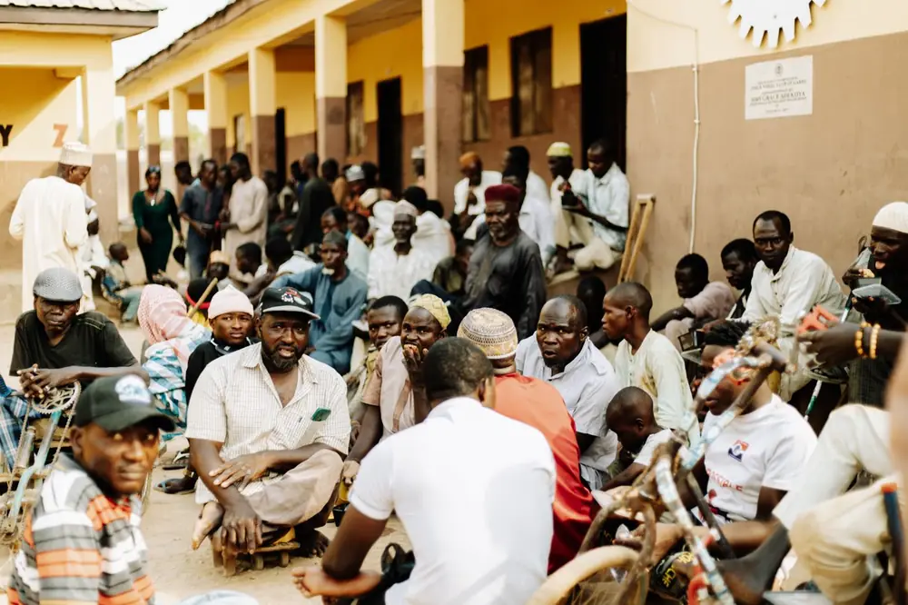 An outdoor gathering of residents at a community centre