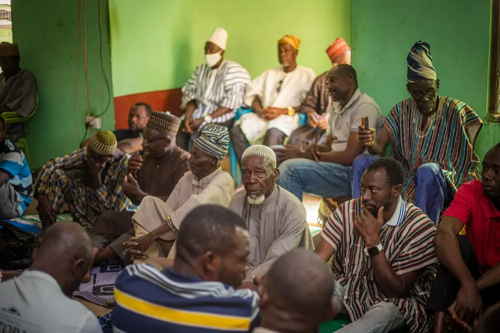 People meeting together in colourful traditional dress