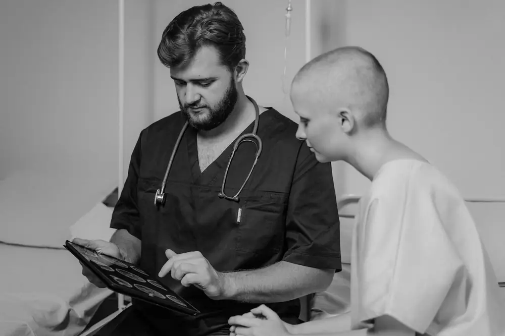 A clinician and patient looking at records on a tablet
