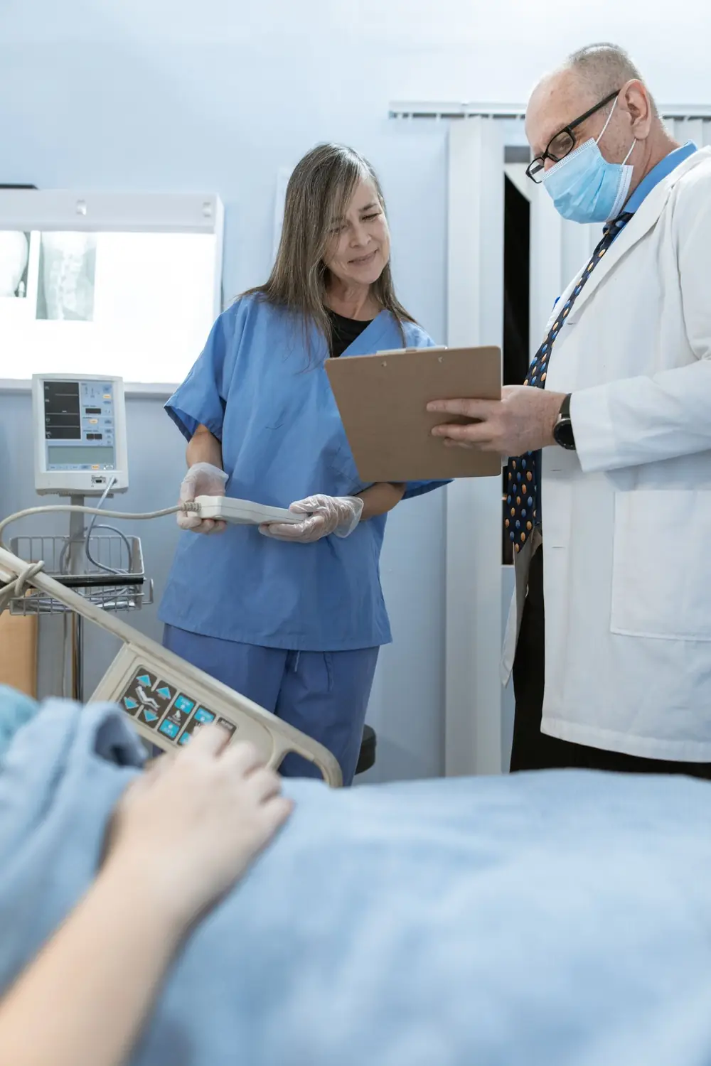 A doctor and nurse reviewing a case together in a hospital