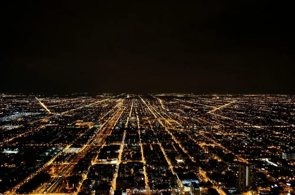 Aerial view of a city grid glowing at night