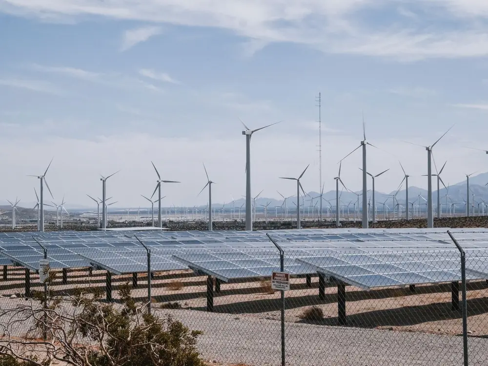 Wind turbines and solar panels on an open energy site
